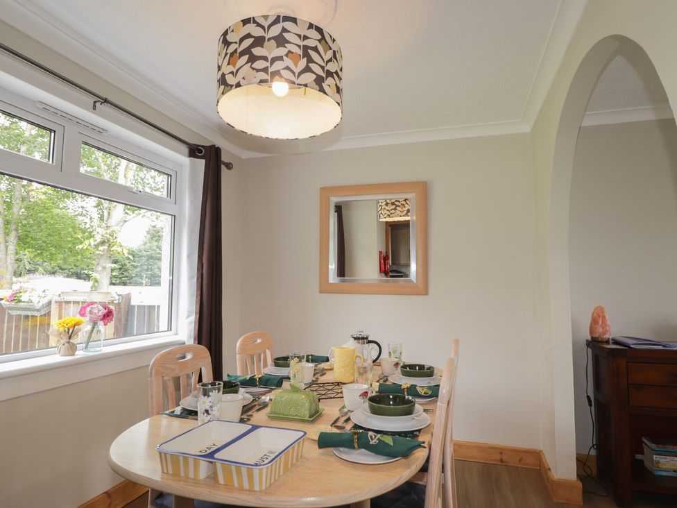 A dining room with a table set for a meal at Taigh Ban in Nairn