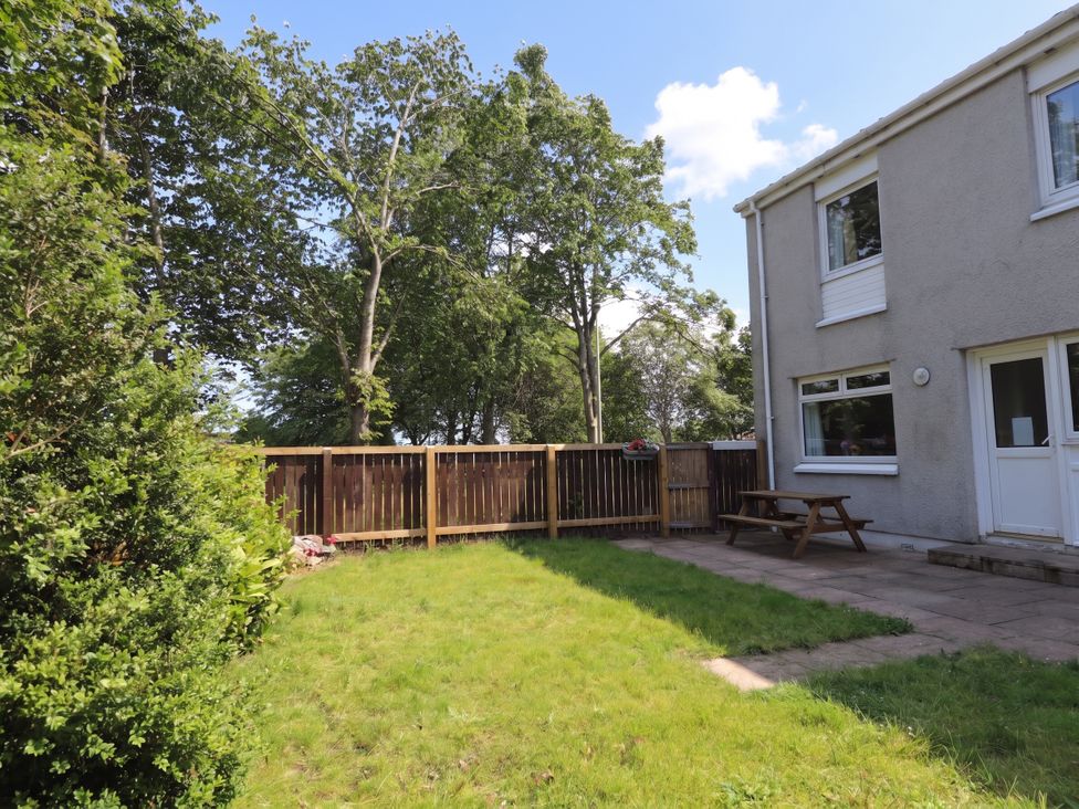 A garden with grass and furniture at Taigh Ban in Nairn