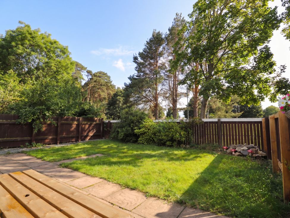 A garden with grass and trees at Taigh Ban in Nairn