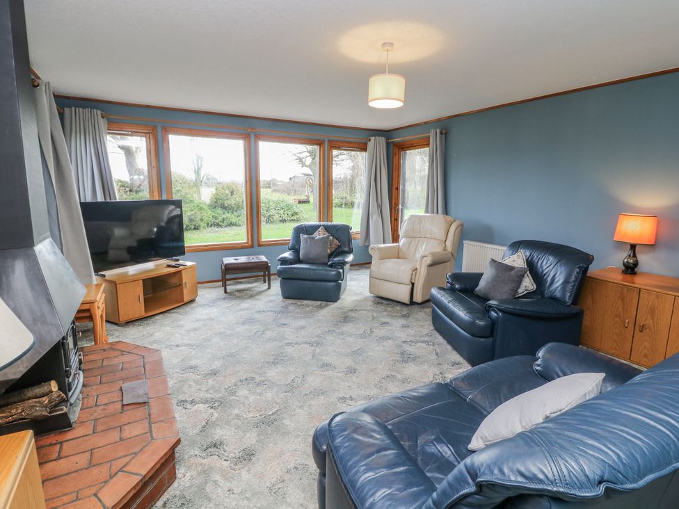 A living room with a TV and sofas at Cherry Trees