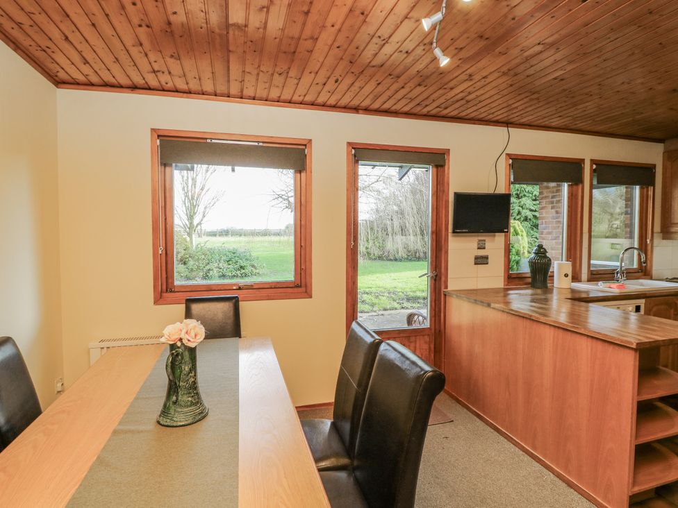 A dining room with a table and chairs at Cherry Trees