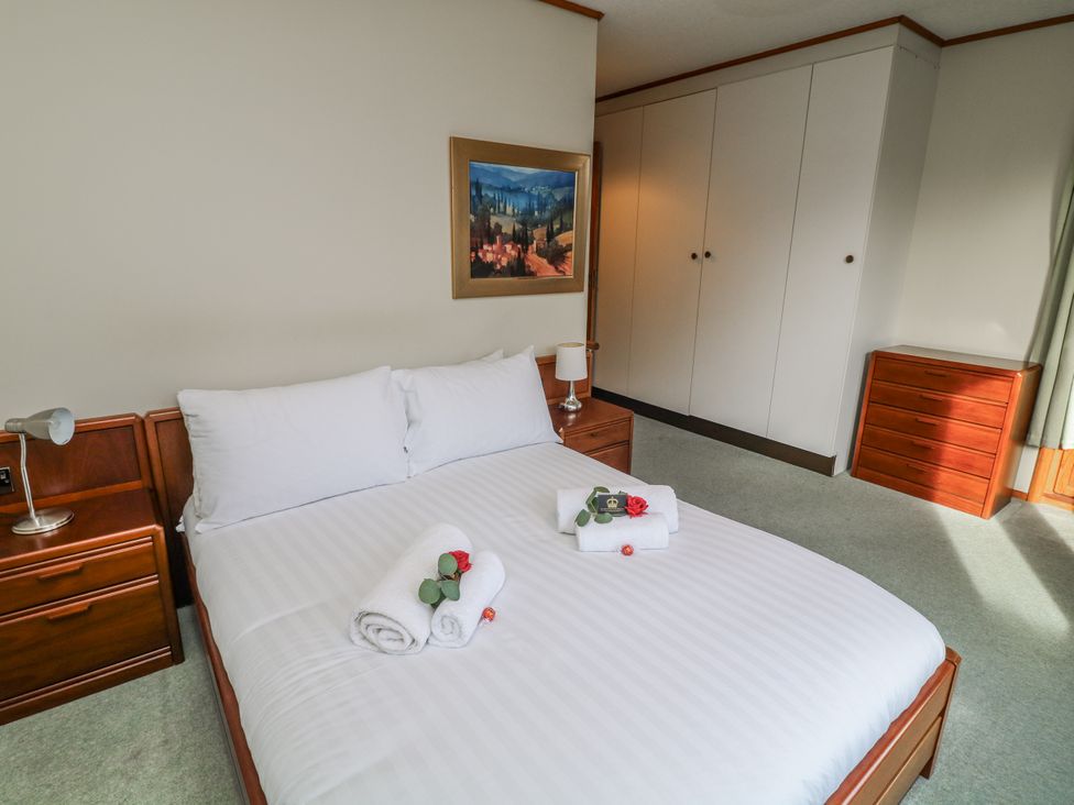 A bedroom with a bed and a wardrobe at Cherry Trees