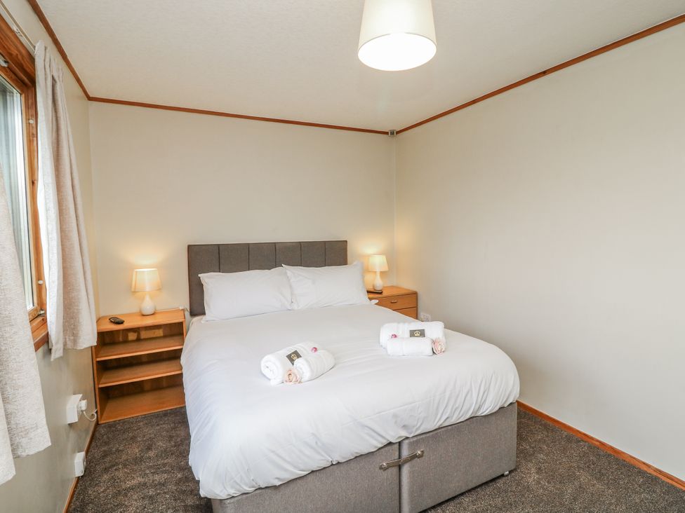 A bedroom with a bed and lamp at Cherry Trees
