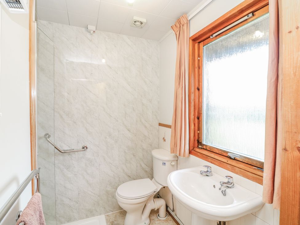 A bathroom with a shower, toilet, and sink at Cherry Trees