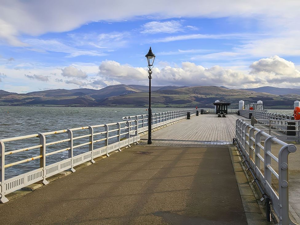 A pier with railings and a lamp post at Tri Raglan Mawr in Beaumaris