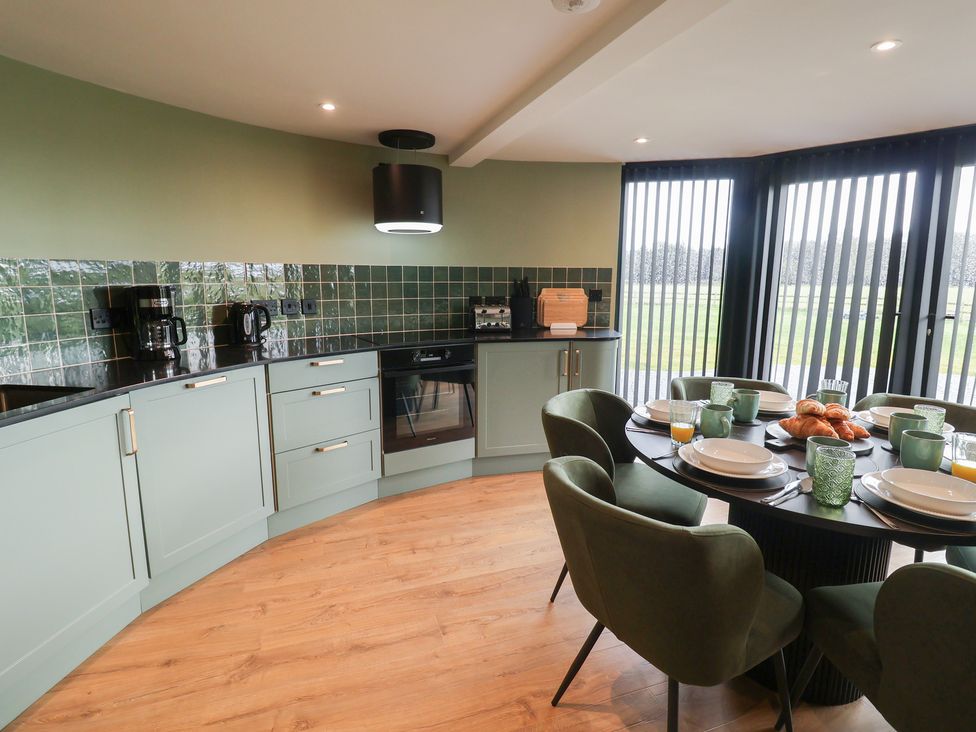 A kitchen with a dining area and appliances at Unit 1 in Ipswich