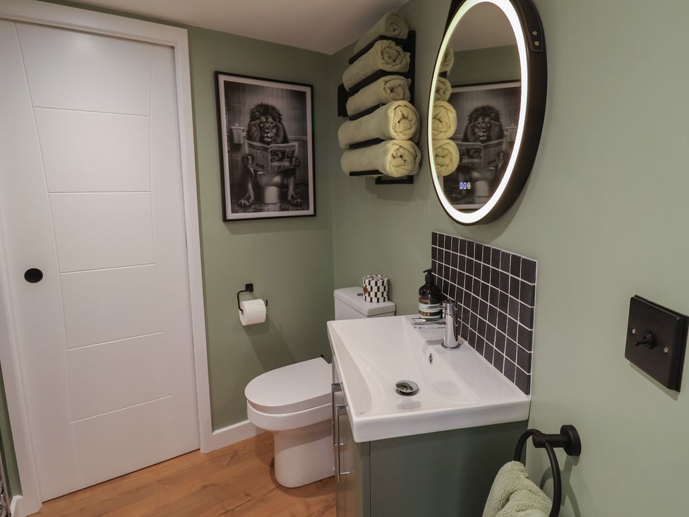 A bathroom with a toilet and sink at Unit 1 in Ipswich