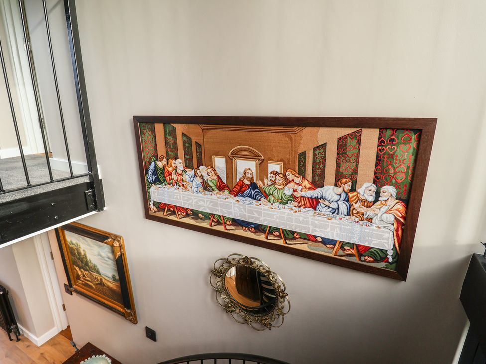 A tapestry depicting The Last Supper on a wall in the stairway at Unit 1 Ipswich