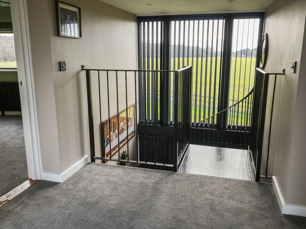 A staircase with a handrail in a hallway at Unit 1 Ipswich