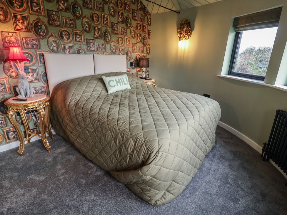 A bedroom with a bed and lamp at Unit 1 in Ipswich