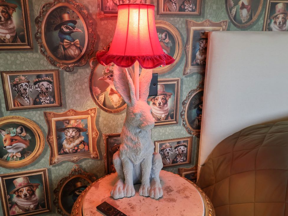 A lamp shaped like a rabbit next to wall art in a bedroom at Unit 1 in Ipswich