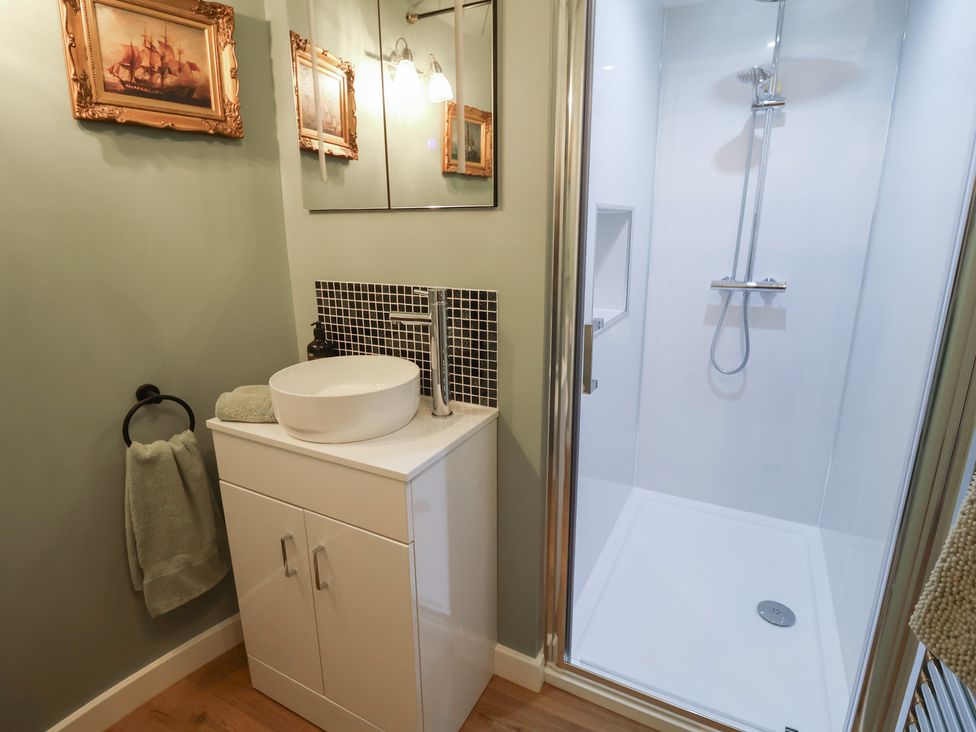 A bathroom with a sink and shower at Unit 1 Ipswich