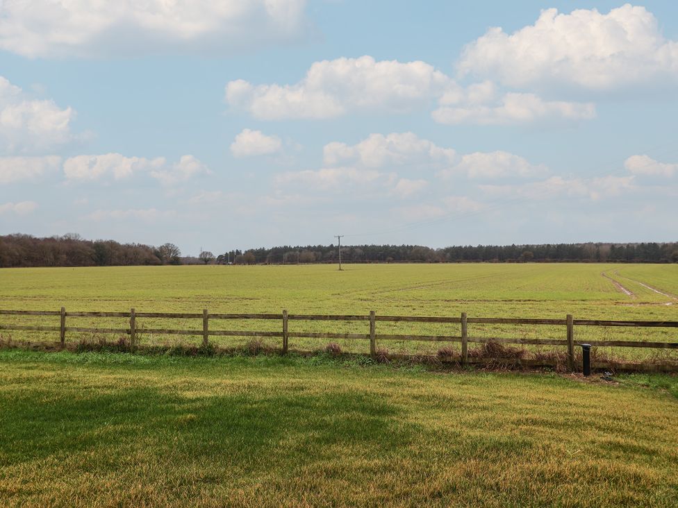 A field with a fence and power pole at Unit 1 in Ipswich