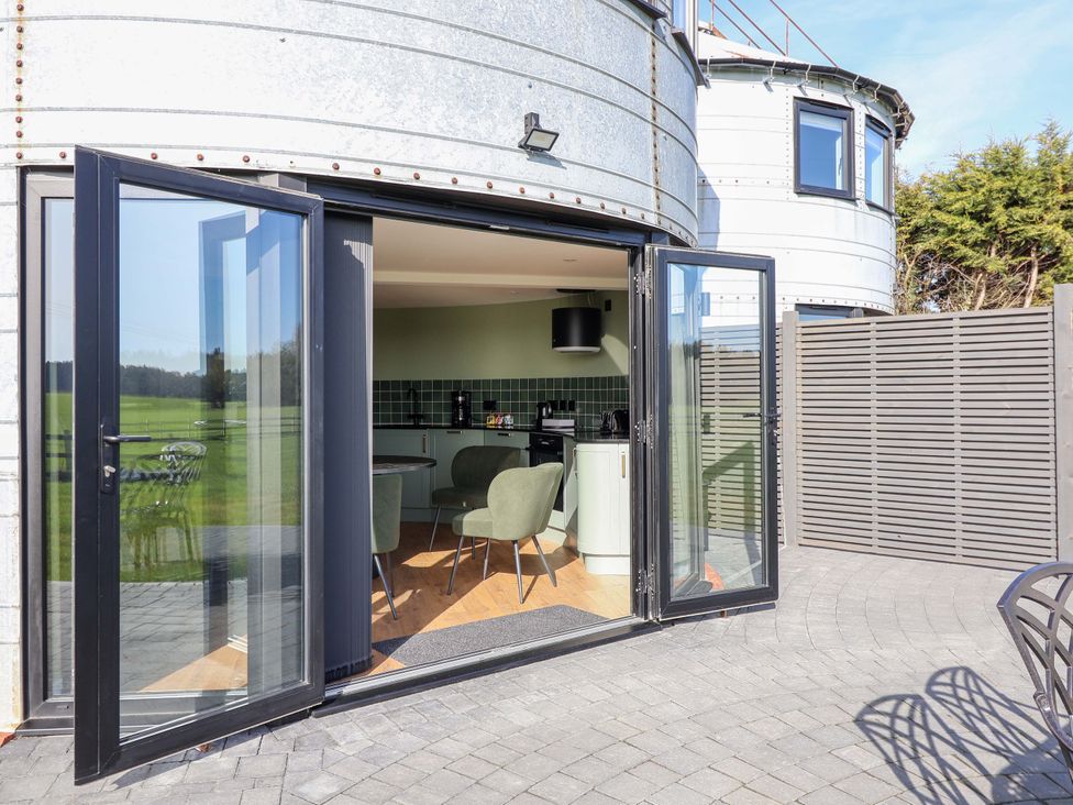 An outdoor area with a kitchen view and seating at The Corn Silo in Ipswich