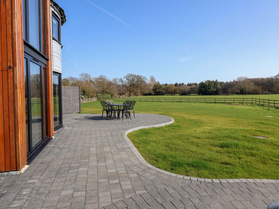 An outdoor patio with a table and chairs at The Corn Silo in Ipswich