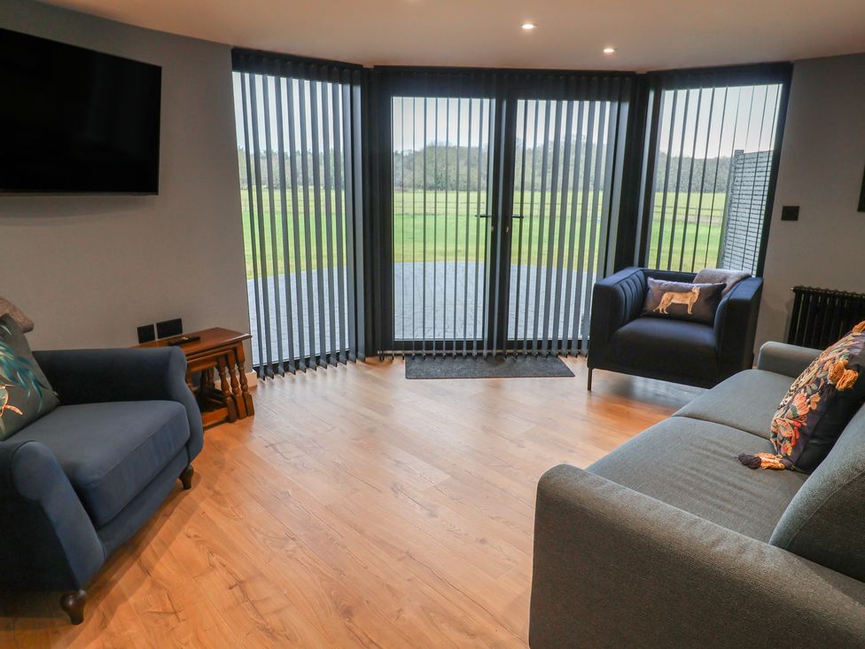 A living room with sofas and a television at Unit 2 in Ipswich