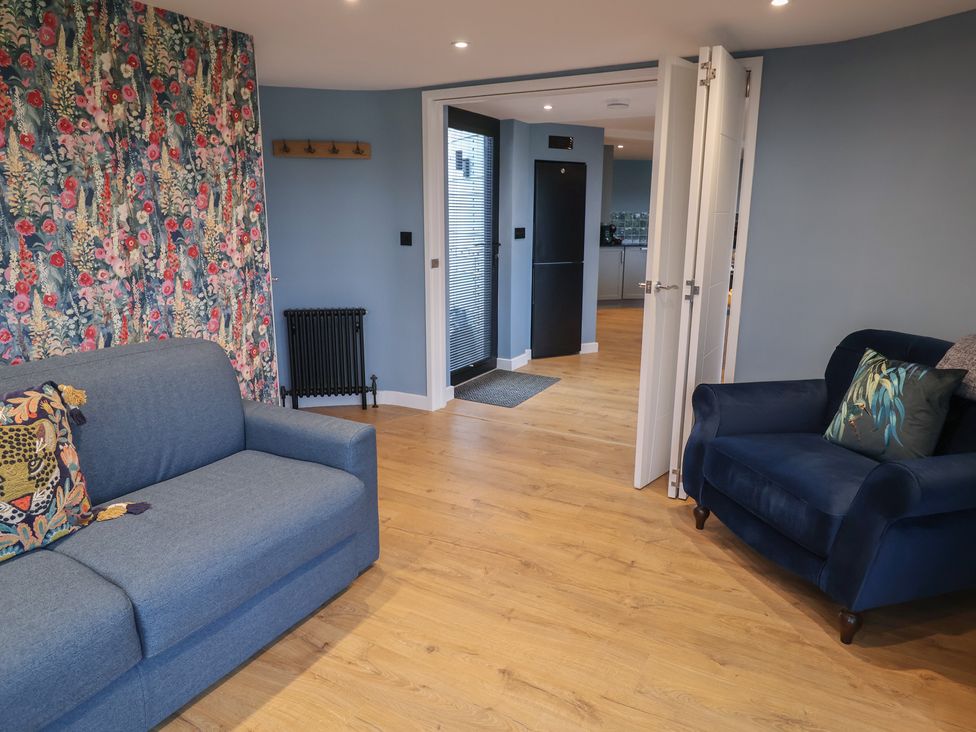 A living room with a sofa and armchair at Unit 2 in Ipswich