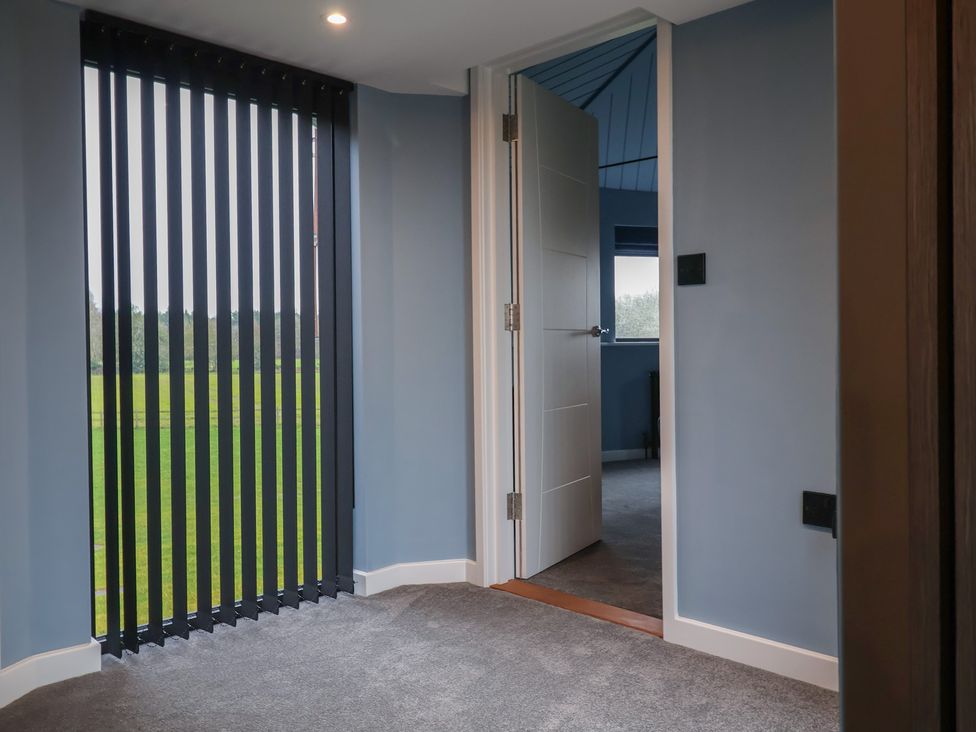 A room with a door and window looking outside at Unit 2 Ipswich