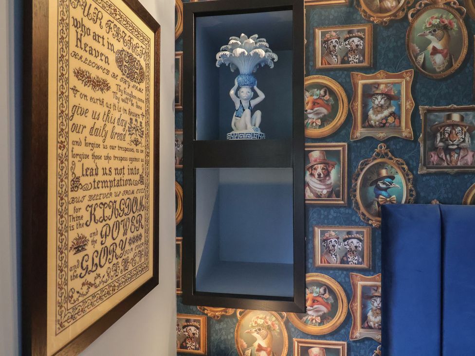 A decorative shelf with a figurine in a room at Unit 2 Ipswich