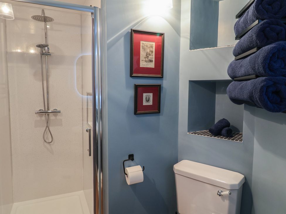A bathroom featuring a shower, toilet, and towels at Unit 2 Ipswich