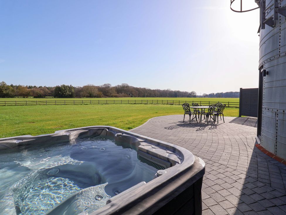 An outdoor area with a hot tub and seating at The Barley Silo in Ipswich