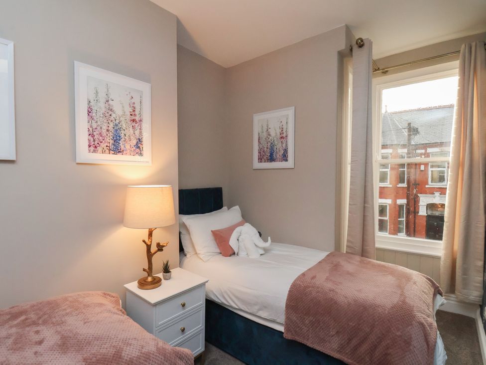 A bedroom with two beds and a lamp at Apartment 2, Blackburn Heights in Bridlington