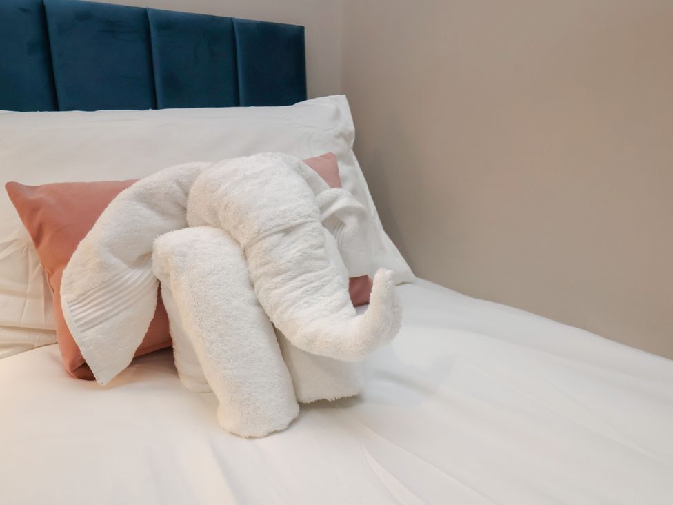 A towel sculpture in the shape of an elephant on a bed at Apartment 2, Blackburn Heights in Bridlington
