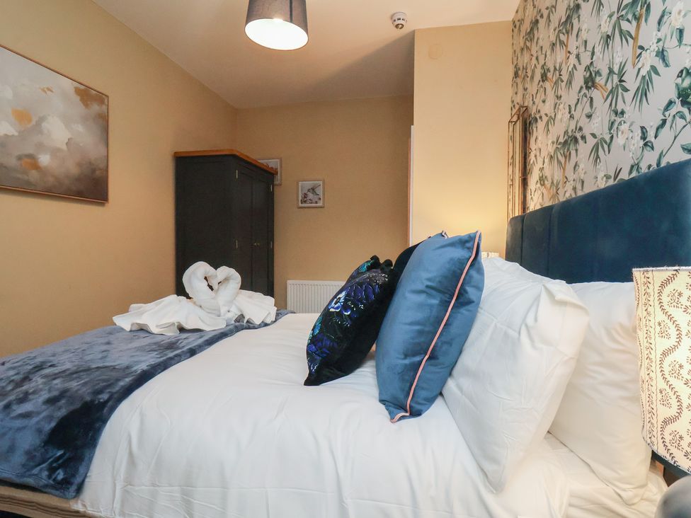 A bedroom with a bed and wardrobe at Apartment 2, Blackburn Heights in Bridlington