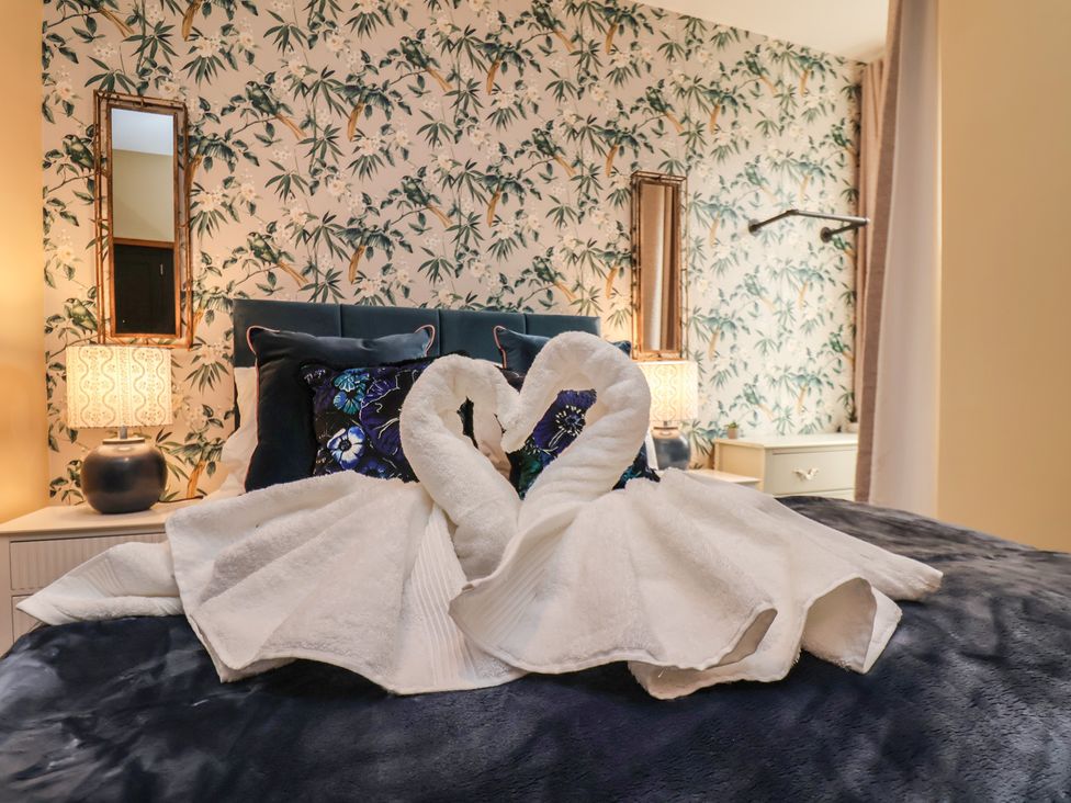A bedroom with a bed and decorative towels at Apartment 2, Blackburn Heights in Bridlington