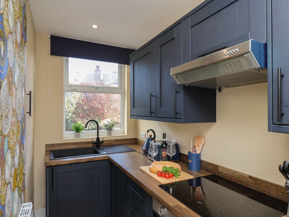 A kitchen with cabinets and a sink at Apartment 2, Blackburn Heights in Bridlington