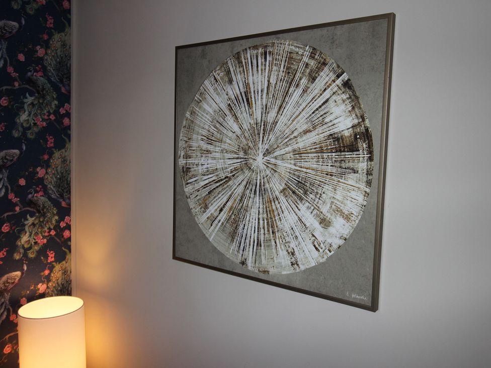 An artwork on the wall and a lamp in a living room at Blackburn Heights Apartment in Bridlington