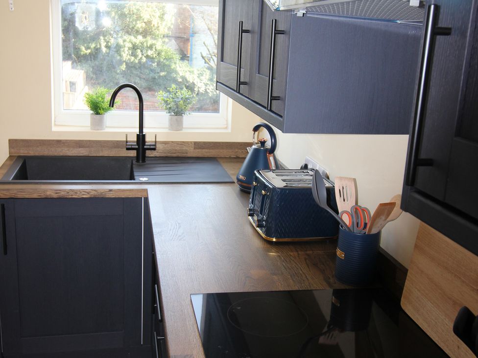 A kitchen with a sink and appliances at Blackburn Heights Apartment in Bridlington