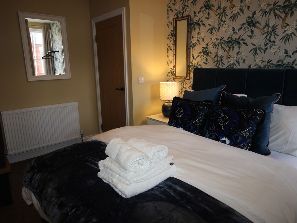 A bedroom with a bed and pillows at Blackburn Heights Apartment in Bridlington