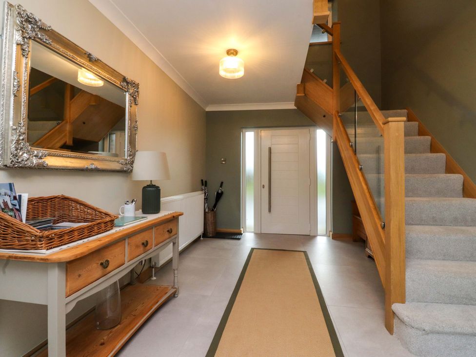 A hallway with a table and mirror at Brook House Broughton, Lancashire