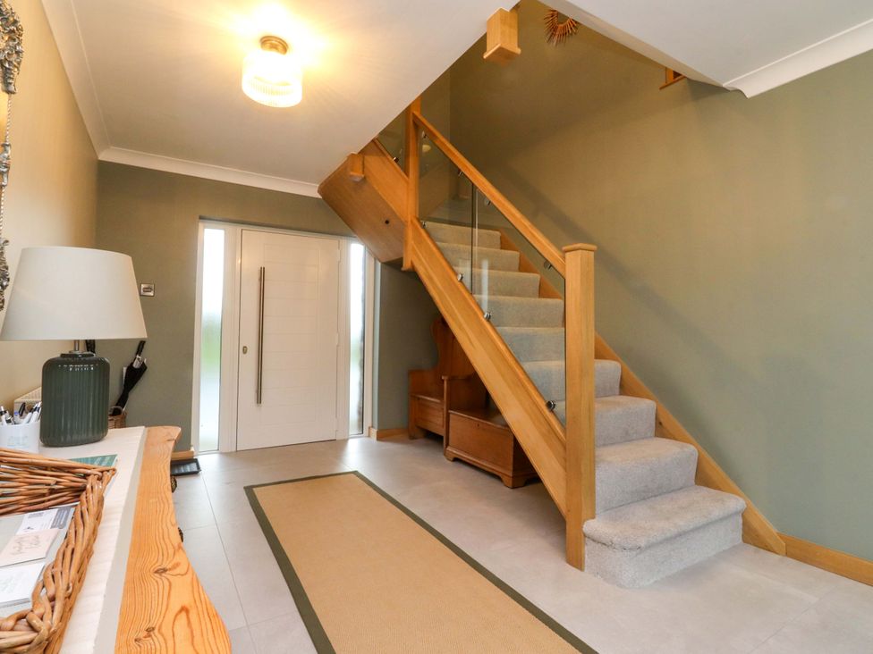 An entrance hall with stairs and a lamp at Brook House in Broughton, Lancashire