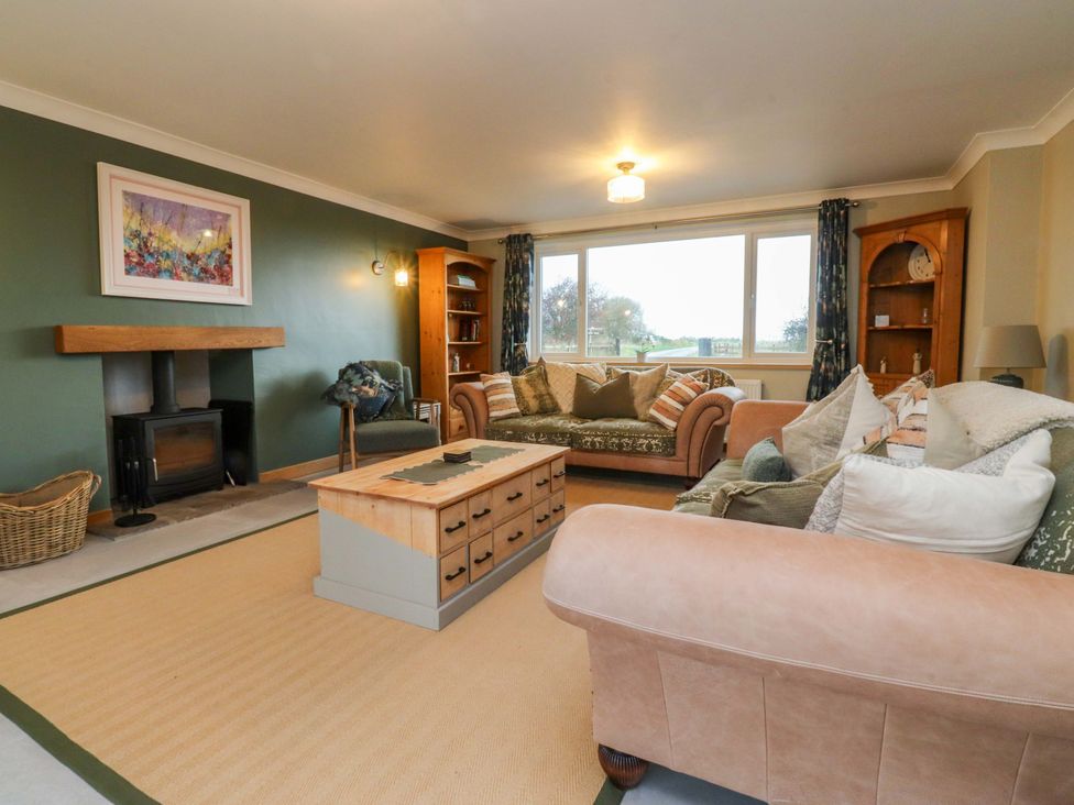 A living room with a sofa, armchair and a coffee table at Brook House in Broughton, Lancashire