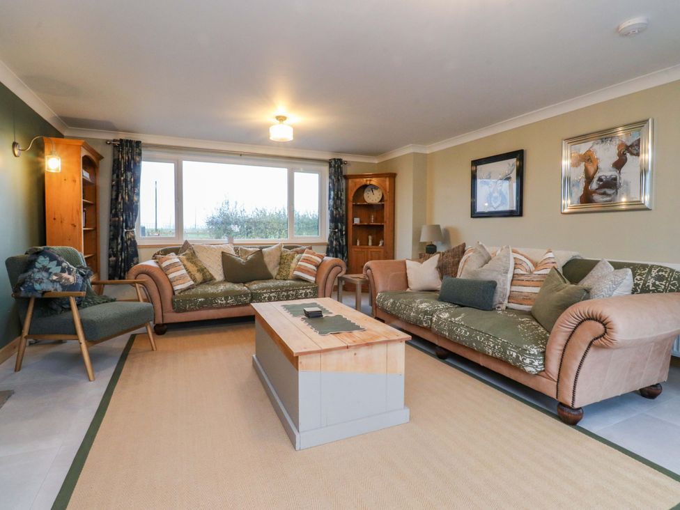 A living room with a sofa and coffee table at Brook House in Broughton, Lancashire