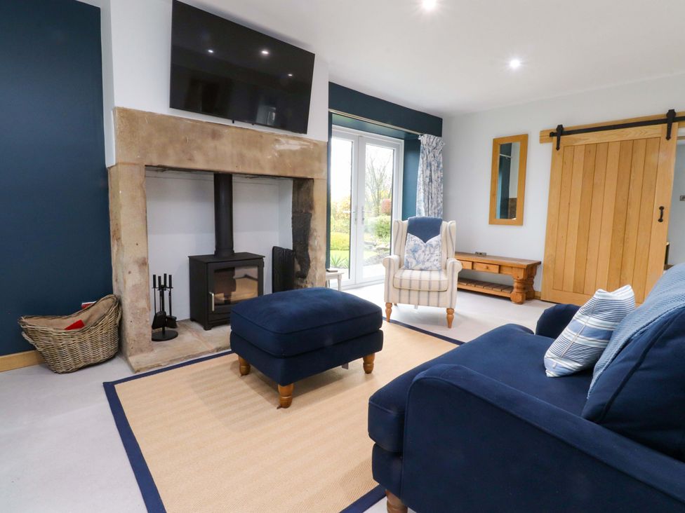 A living room with furniture including a sofa and armchair at Brook House Broughton Lancashire