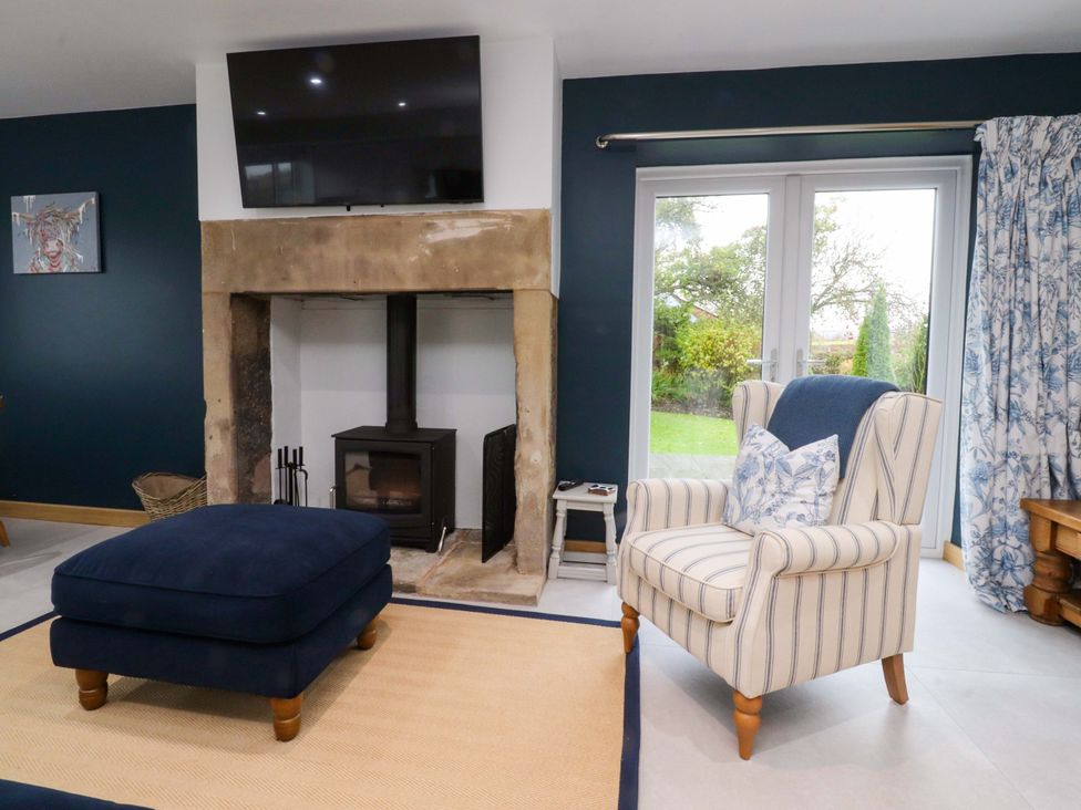 A living room with a television and fireplace at Brook House, Broughton, Lancashire