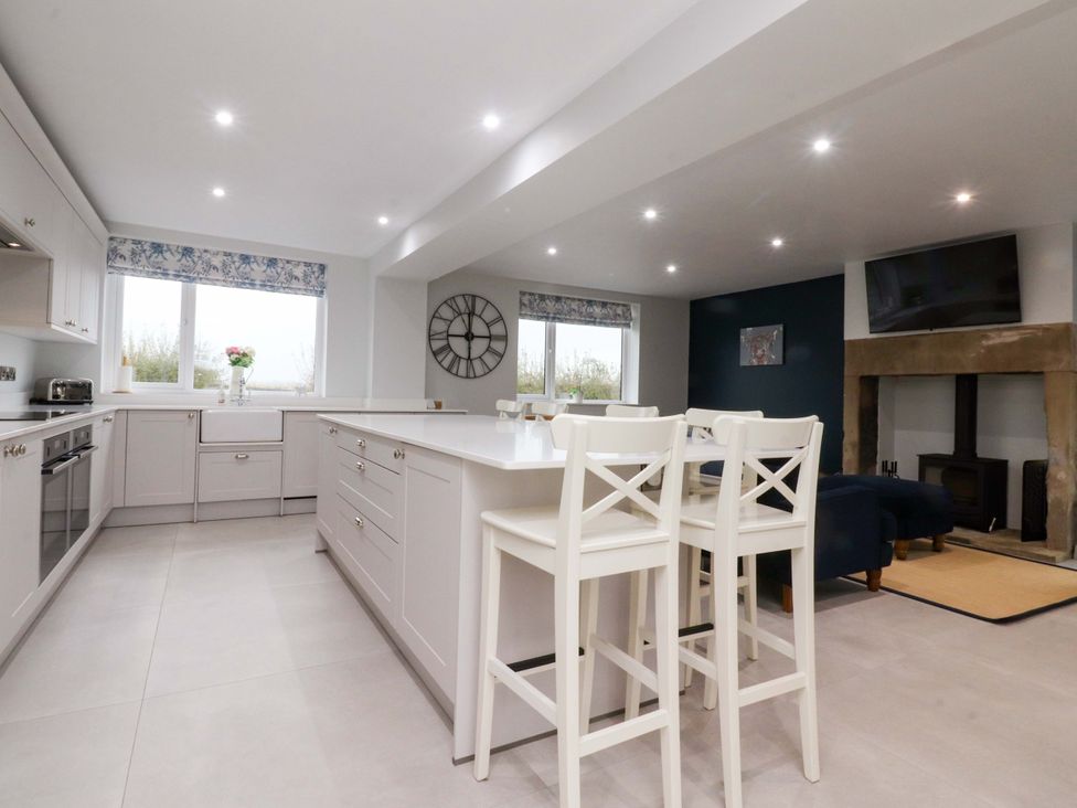 A kitchen with cabinets and an island in Brook House, Broughton, Lancashire
