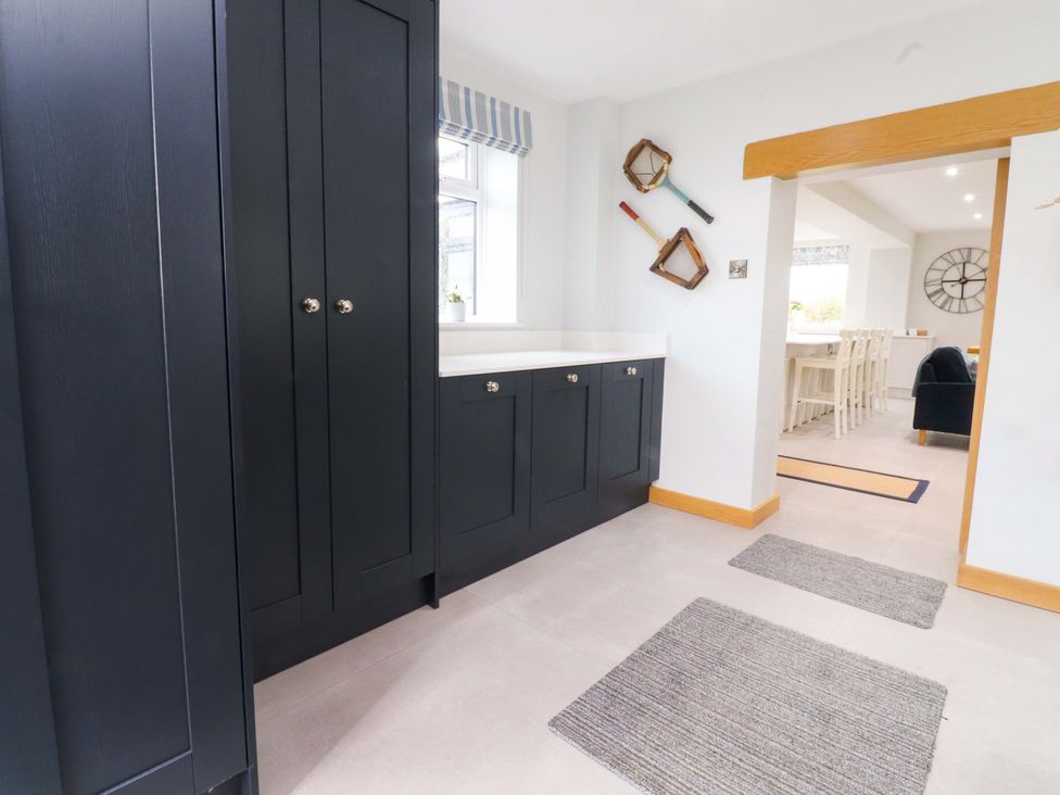 A kitchen with cabinets and a window at Brook House in Broughton, Lancashire