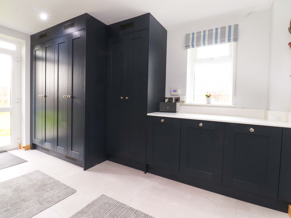 A utility room featuring wardrobes and a counter at Brook House in Broughton, Lancashire