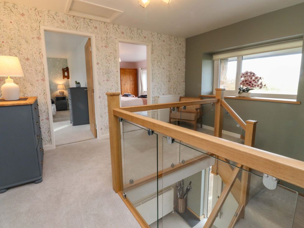 A landing area with staircase and dresser at Brook House in Broughton, Lancashire