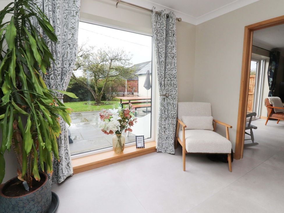 A living room with a window and chair at Brook House in Broughton, Lancashire