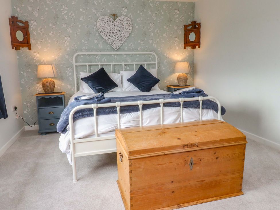 A bedroom with a bed and wooden storage chest at Brook House in Broughton, Lancashire