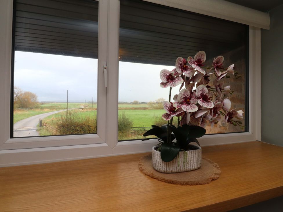 A window with an orchid on the sill at Brook House in Broughton, Lancashire
