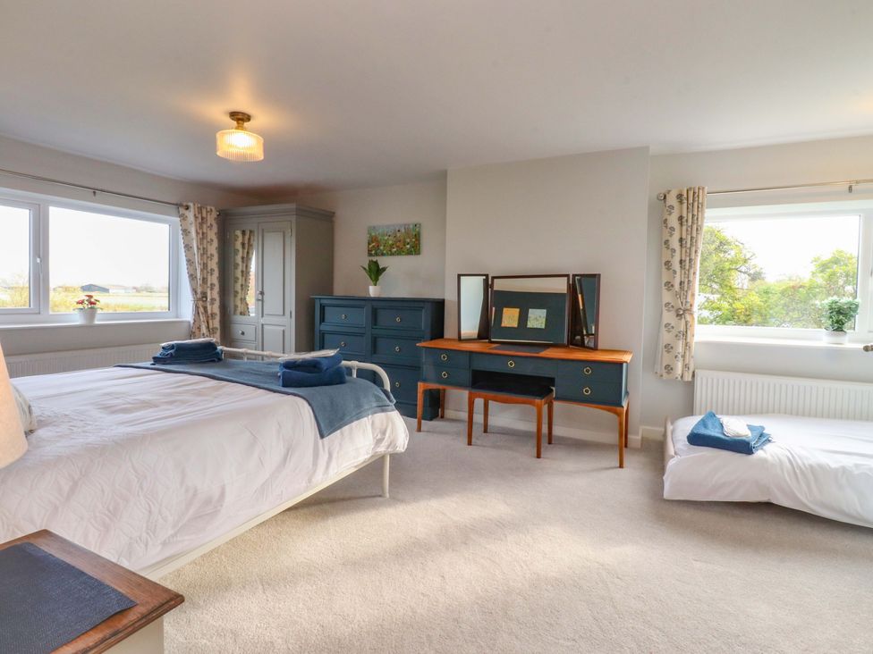 A bedroom with a bed and dresser at Brook House in Broughton, Lancashire
