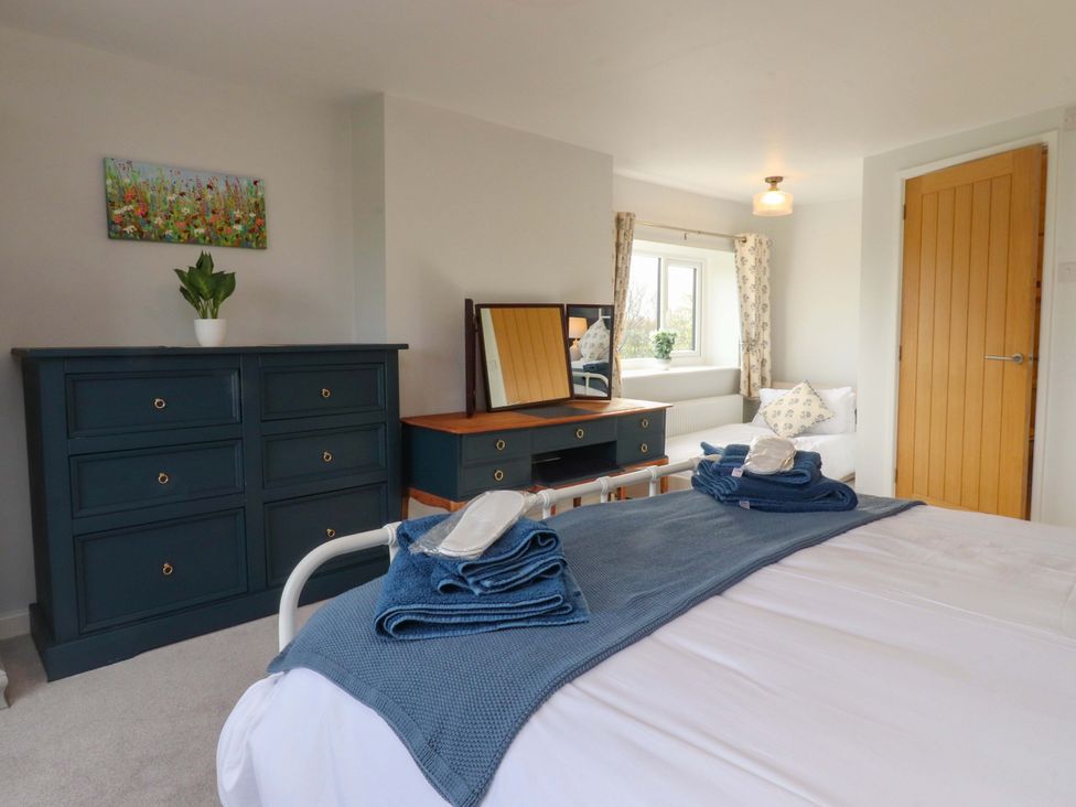 A bedroom with a bed and dresser at Brook House in Broughton, Lancashire