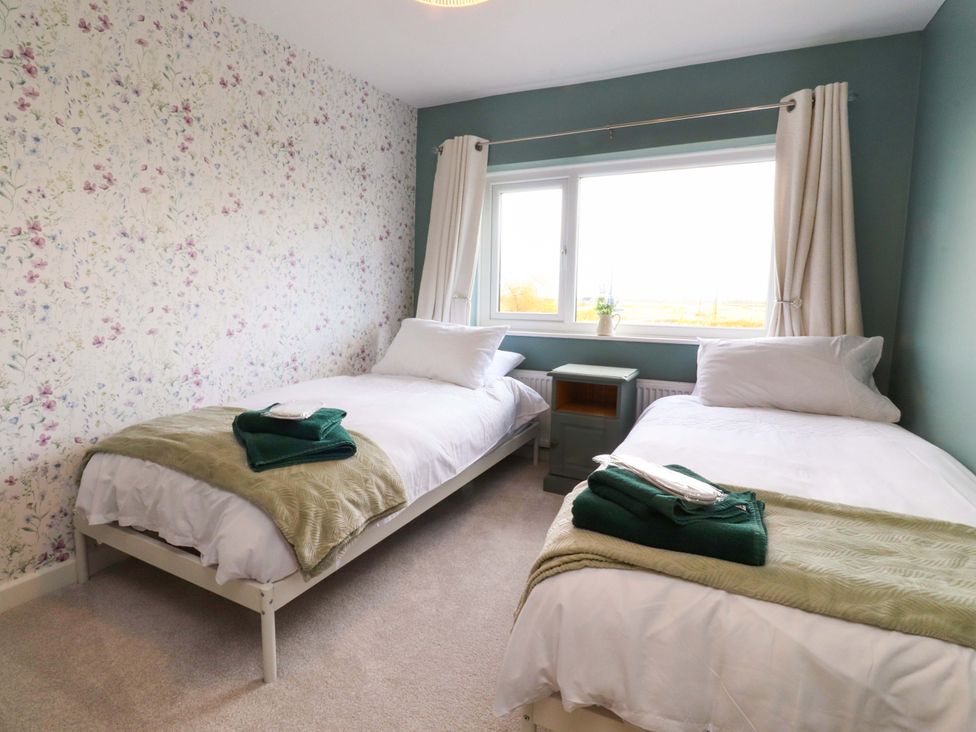 A bedroom with two single beds and a window at Brook House, Broughton, Lancashire