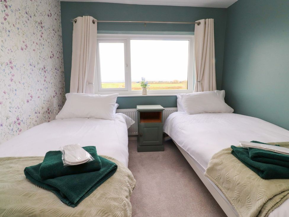 A bedroom with two single beds and a window at Brook House in Broughton, Lancashire